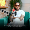 Pete Wicks sitting on a teal couch with a microphone, holding a Skins Lix Rose Buddy, in a studio setting.