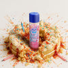 Skins birthday cake lube on a cake with colourful sprinkles and a white background