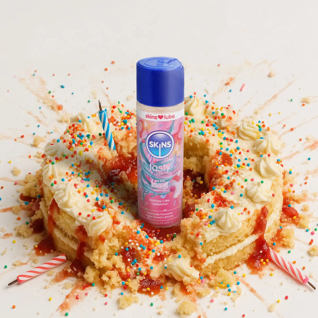 Skins birthday cake lube on a cake with colourful sprinkles and a white background