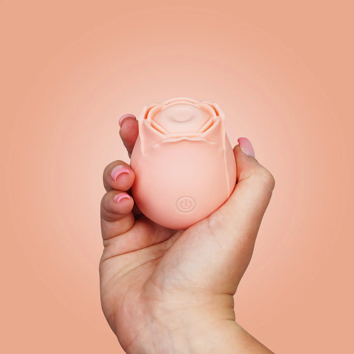 A woman's hand holding a flutterz rose toy 