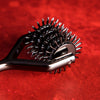 Metallic spiked roller on a red background