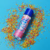 Skins birthday cake lube surrounded by colourful sprinkles on a blue background