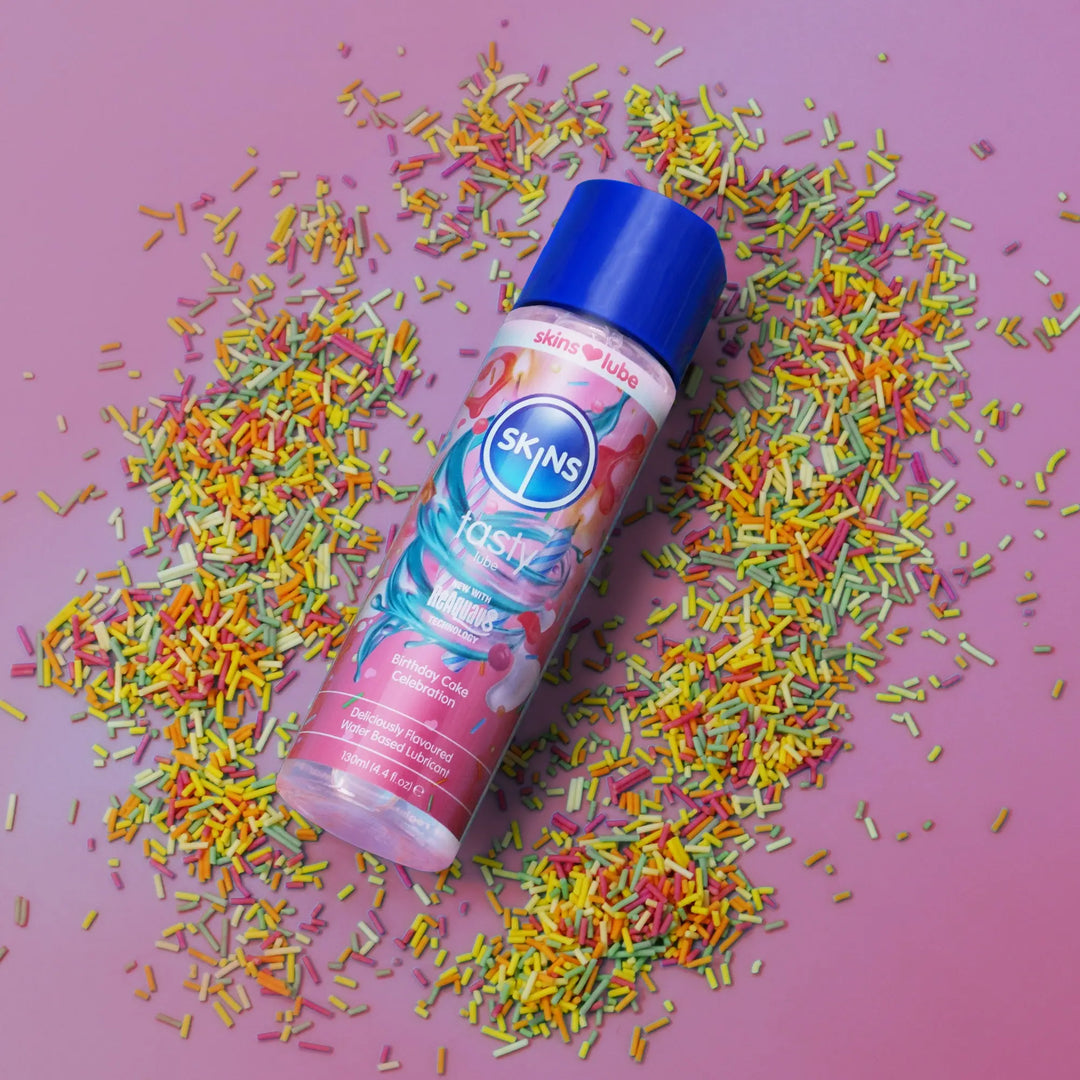 Skins birthday cake luke bottle with coluorful sprinkles on a pink background