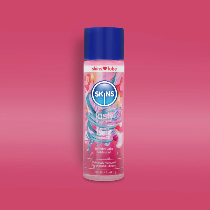 Skins birthday cake lube bottle with colourful design on a pink background