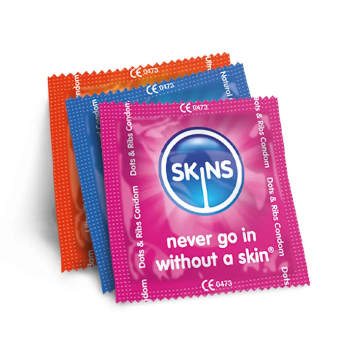 Three SKINS branded condoms in red, blue, and pink on a white background.