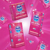SKINS Dots & Ribs condoms packaging on a pink background