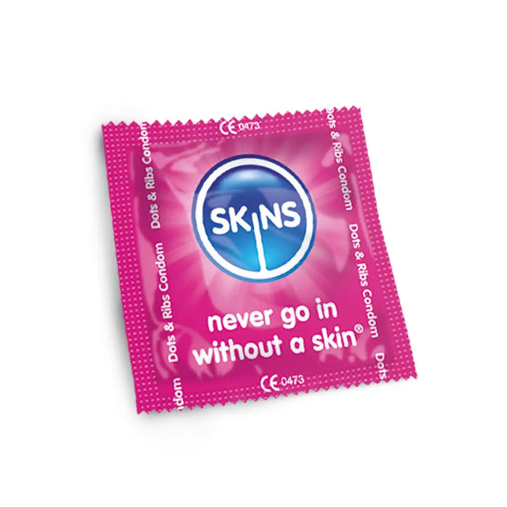 Pink condom package with Skins branding on a white background