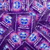 Multiple Skins brand condoms with purple and blue packaging.