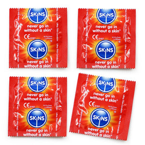 4 ultra thin skins condom foils on a white background
