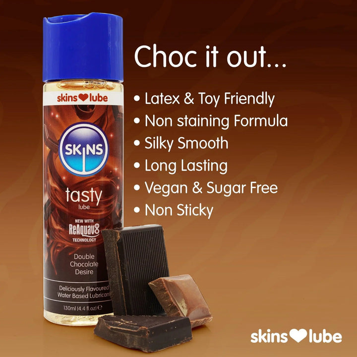 A brown gradient background with a Skins chocolate lube stood to the left with 3 pieces of chocolate. To the right of the lube some key points about the Skins Chocolate lube