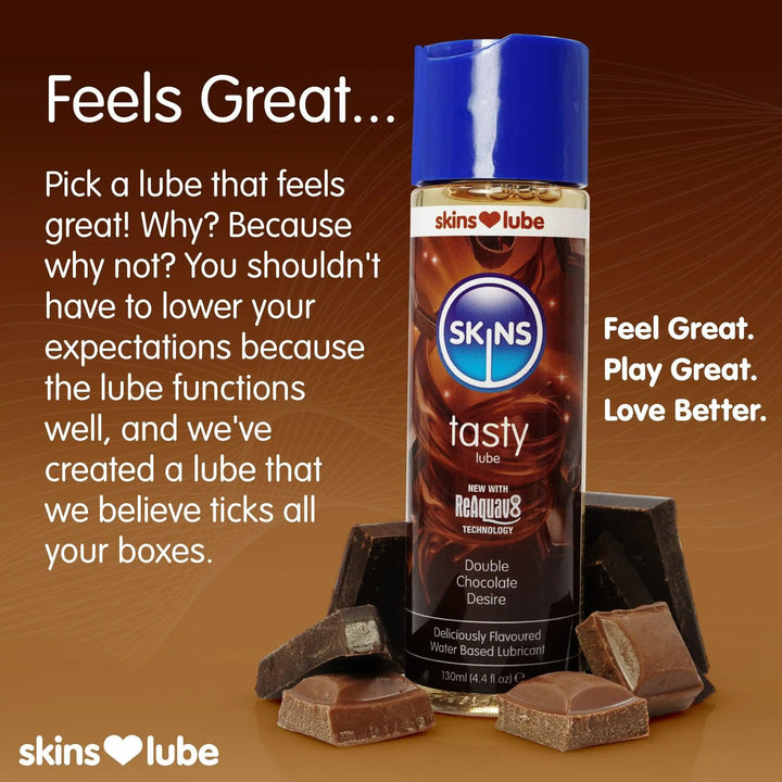 A brown gradient background with a bottle of Skins Chocolate lube to the right surrounded by pieces of chocolate. To the left, some information on why the Skins lubes feel so good