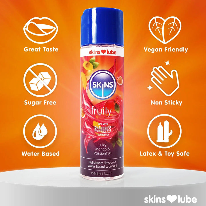 An orange background, getting lighter towards the middle where a bottle of Mango&Passionfruit lube stands on a white platform. Each side of the lube are 3 USP icons. 